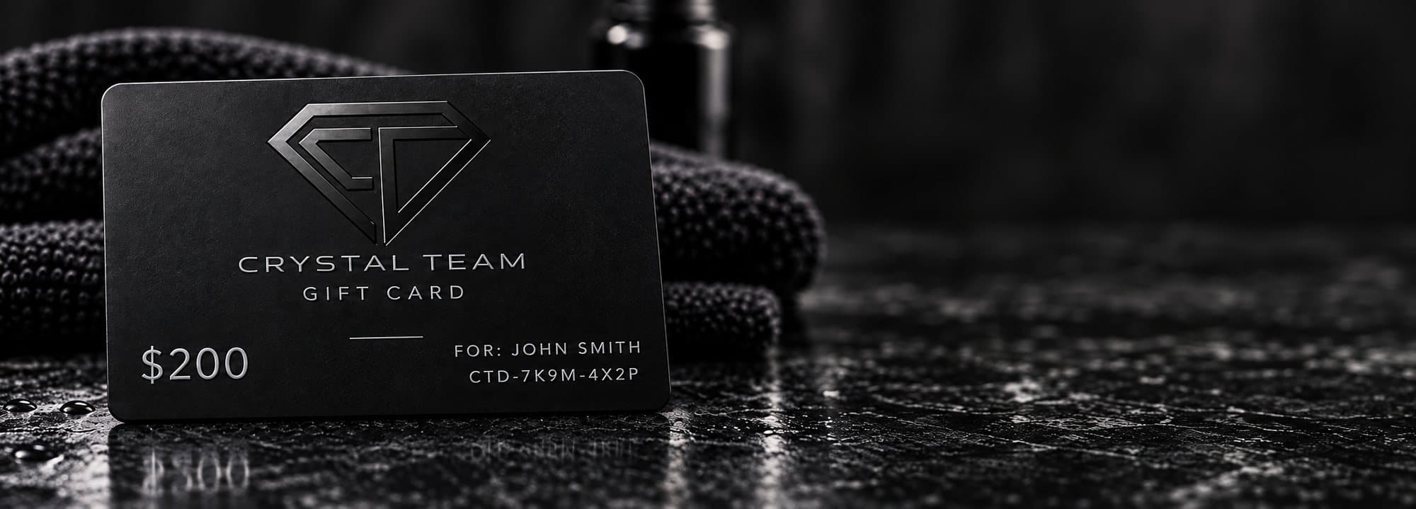 Black Crystal Team gift card resting on a microfiber towel