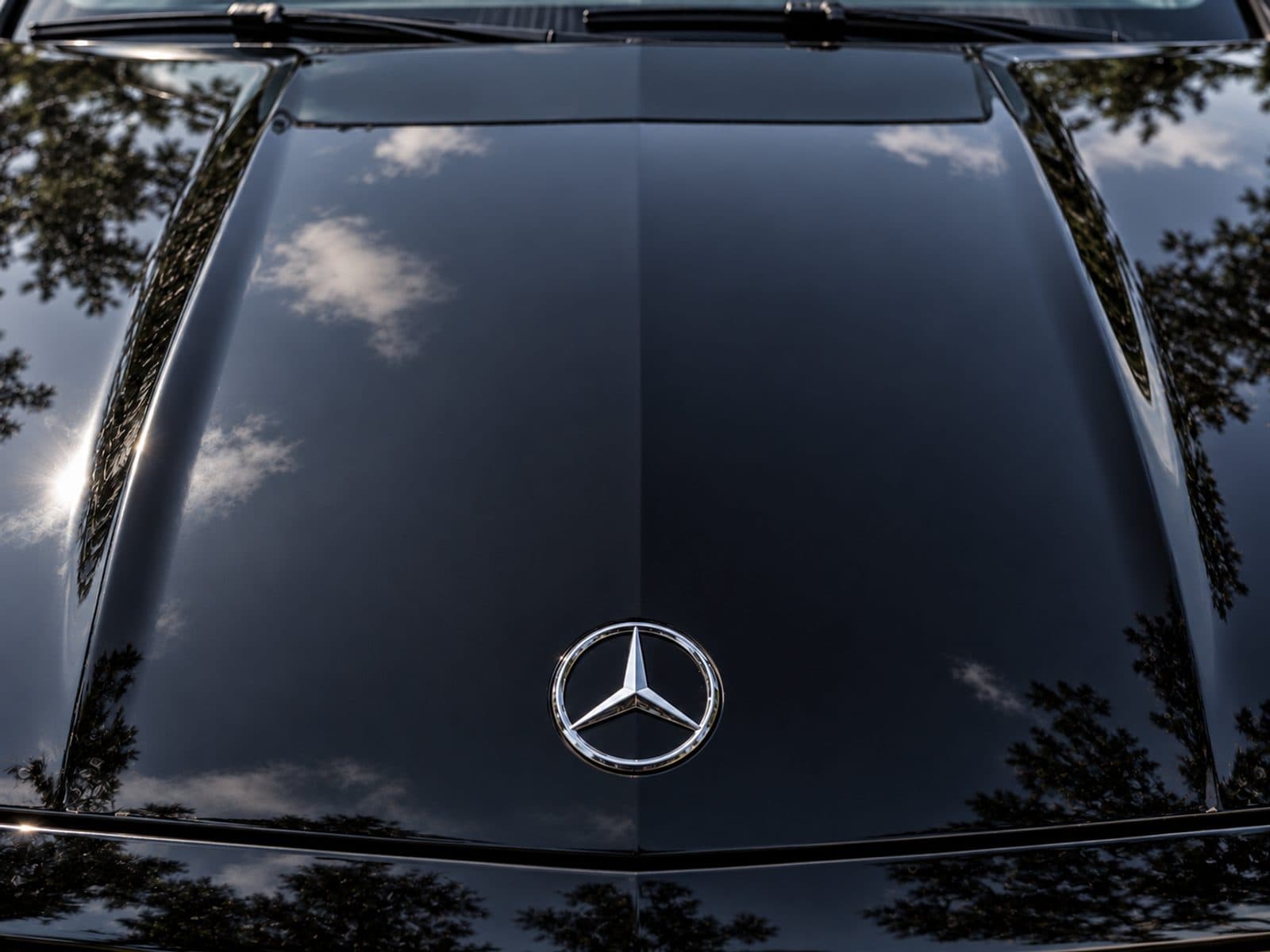 The same Mercedes hood after detailing, glossy with clear reflections
